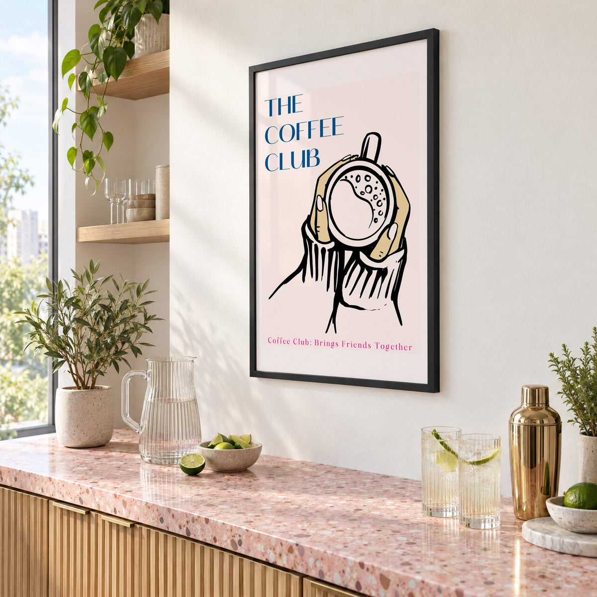 The Coffee Club hands and cup print in a black frame above a pink terrazzo cocktail counter with limes, seen at an angle