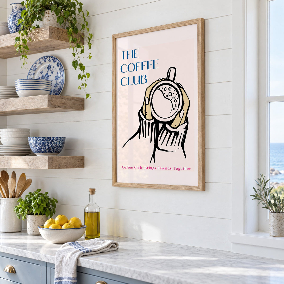 The Coffee Club hands and cup print in an oak frame in a white coastal kitchen beside blue and white plates