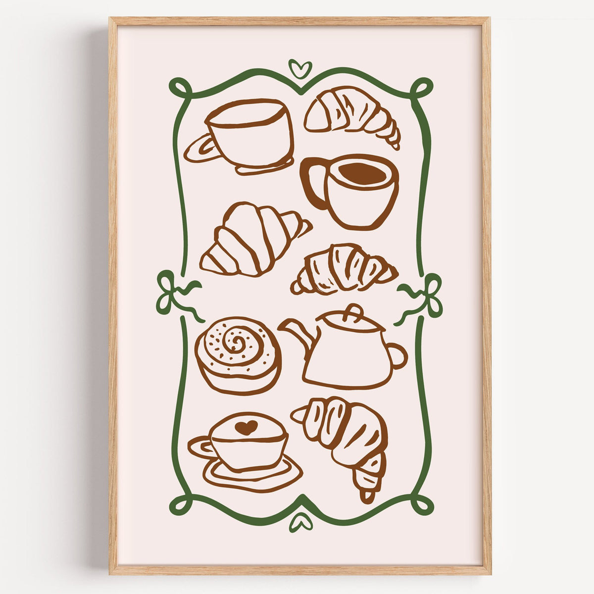 Coffee and croissant doodles green frame print in a light oak frame on a plain white wall