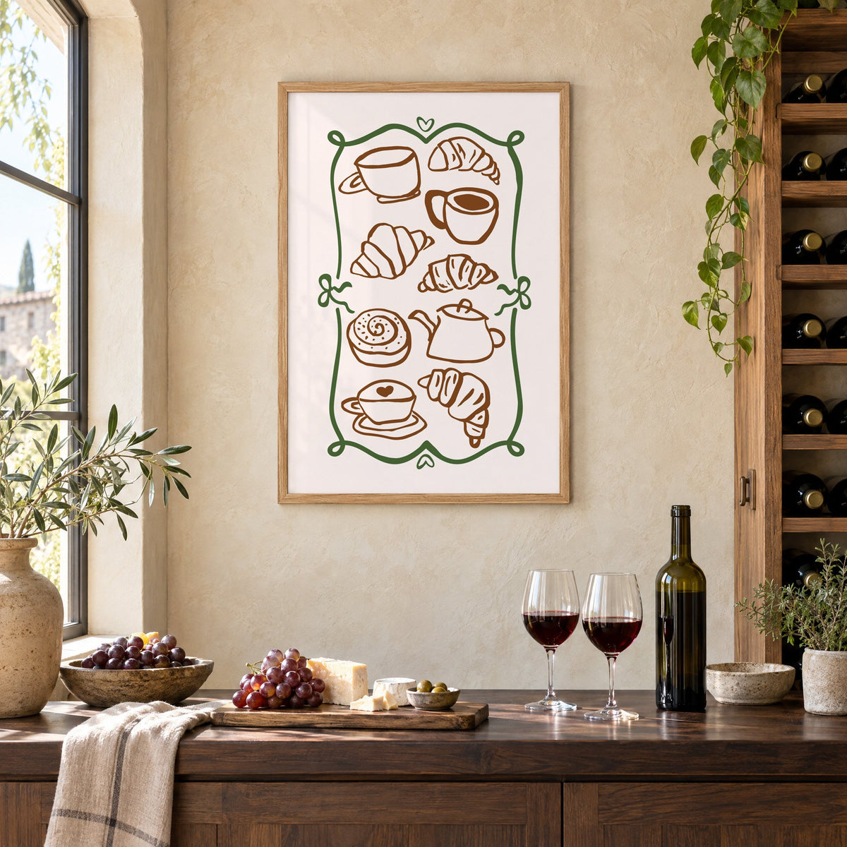 Coffee and croissant doodles green frame print in an oak frame on a limewashed wall above a wine counter with red wine, cheese and grapes