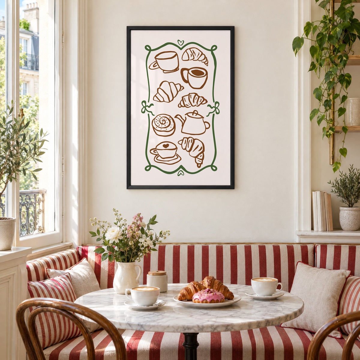 Coffee and croissant doodles green frame print in a black frame above a striped cafe breakfast nook with cappuccino and pastries