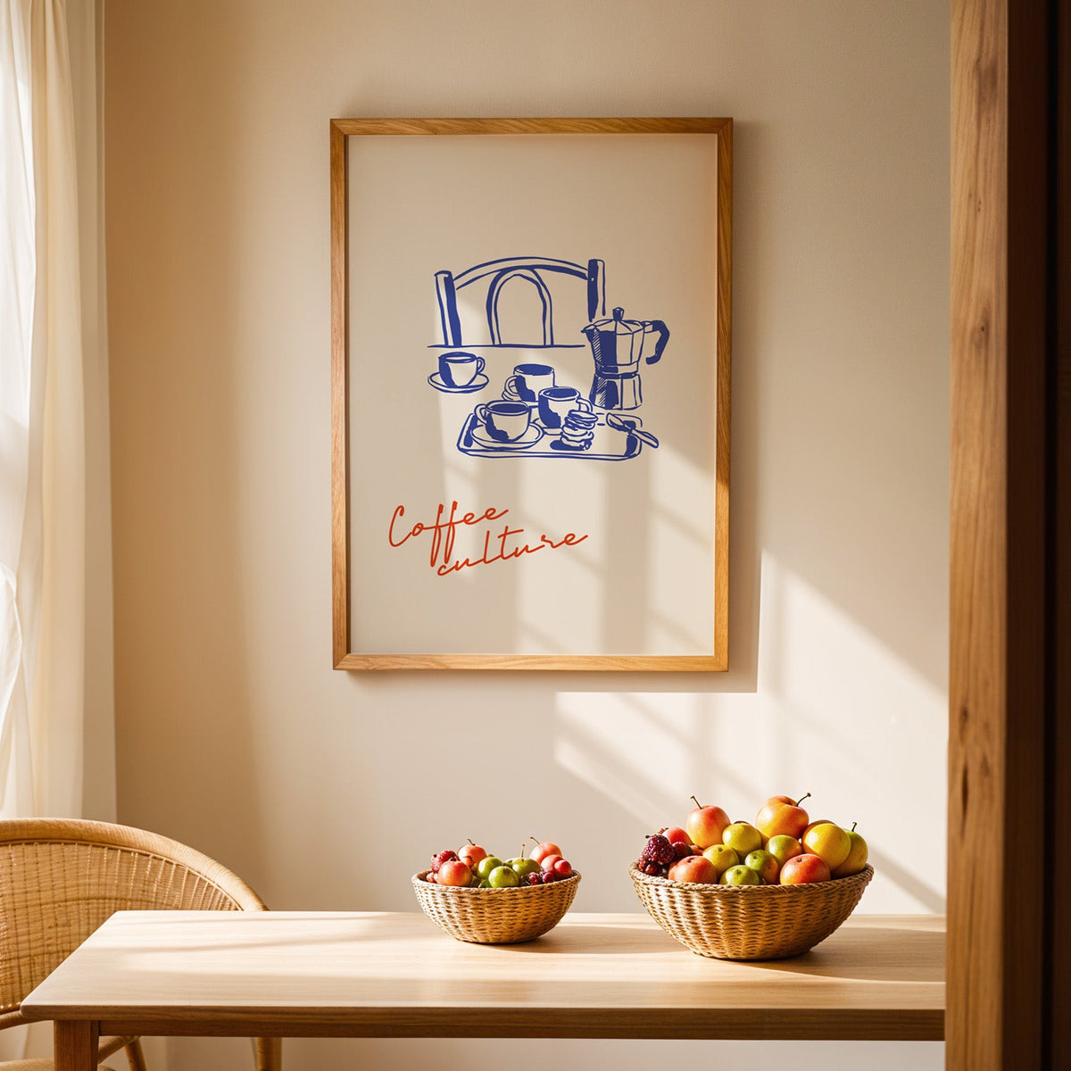 Moka pot espresso print in an oak frame hung above a dining table with wicker bowls of fruit