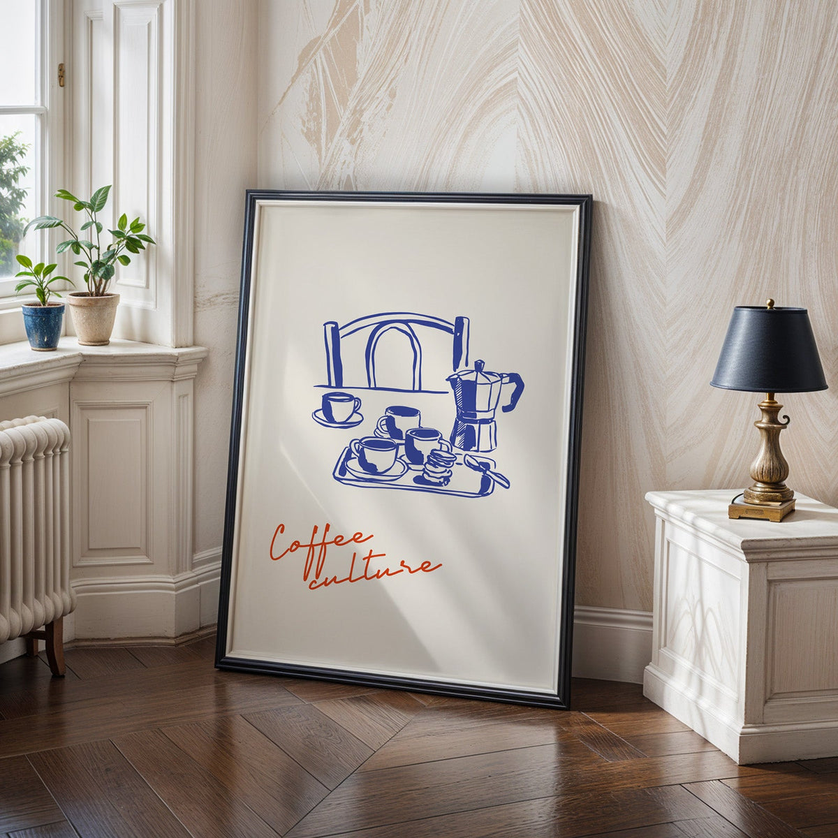 Moka pot poster in a black frame leaning on a herringbone wood floor in a panelled hallway