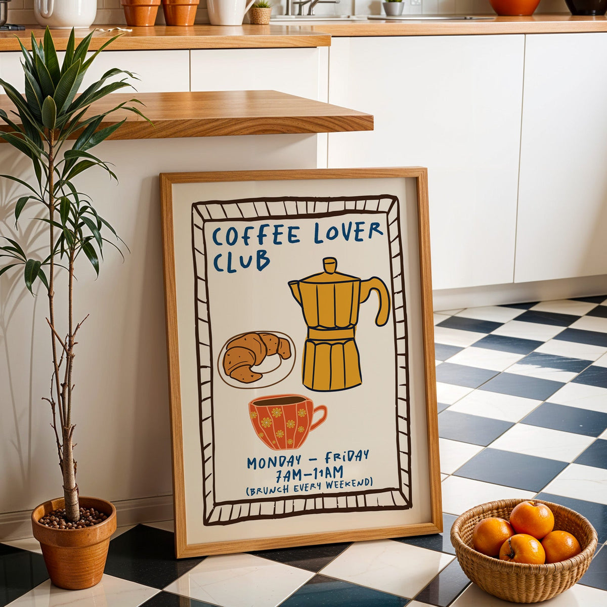 Coffee lover club moka pot print in an oak frame by a kitchen island and checkered floor