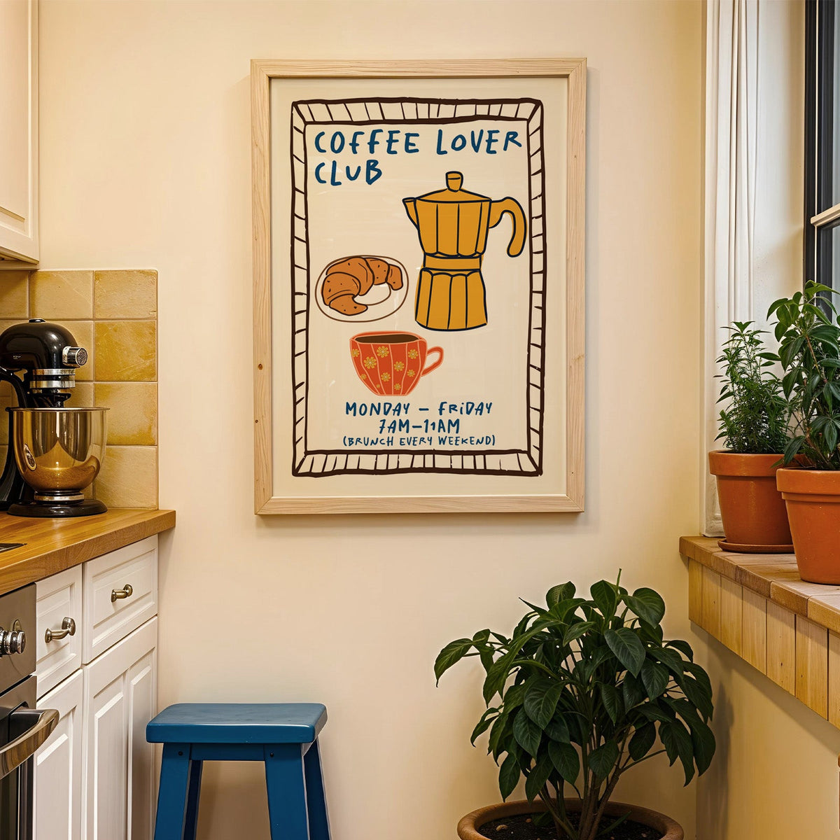 Coffee lover club moka pot print in a wood frame on a yellow tiled kitchen wall