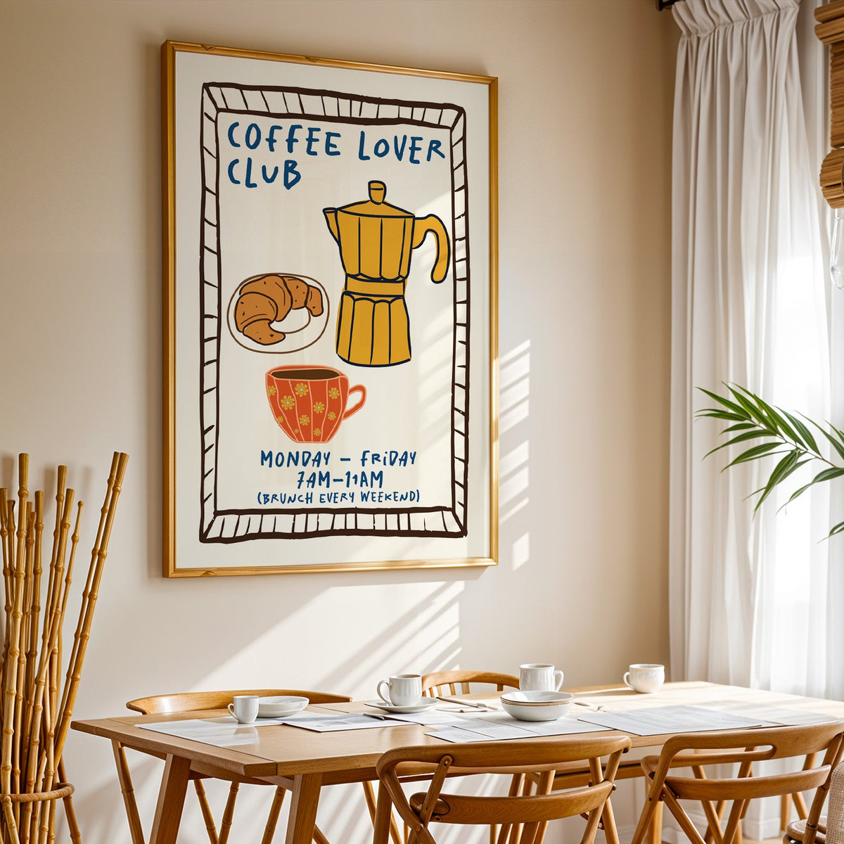 Coffee lover club moka pot print in a gold frame above a sunlit breakfast table