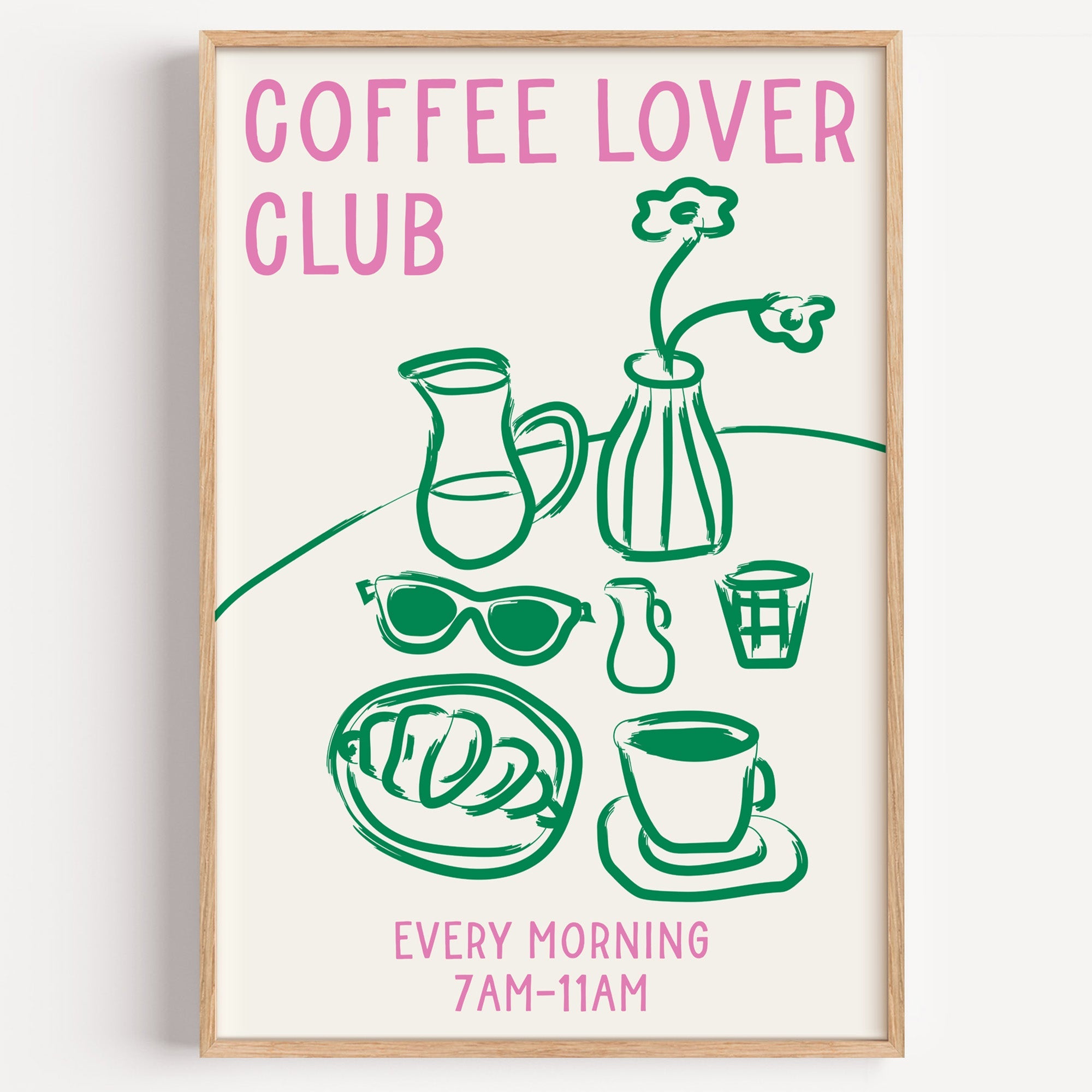 Coffee lover club morning print in a light oak frame on a plain white wall