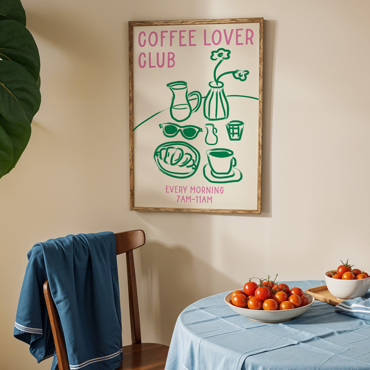 Coffee lover club morning print in an oak frame above a blue linen table with ripe tomatoes