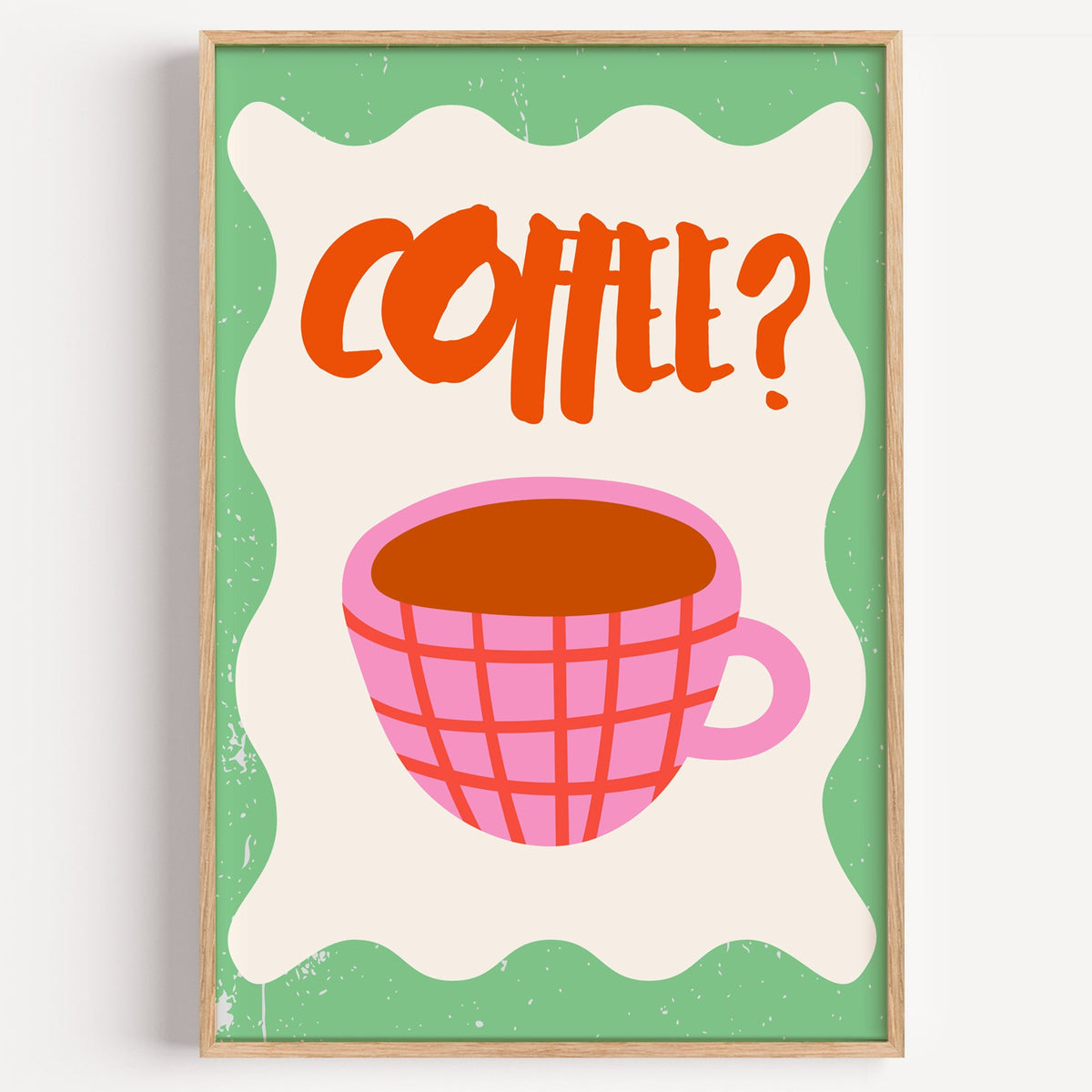 Pink check coffee cup print in a light oak frame on a plain white wall