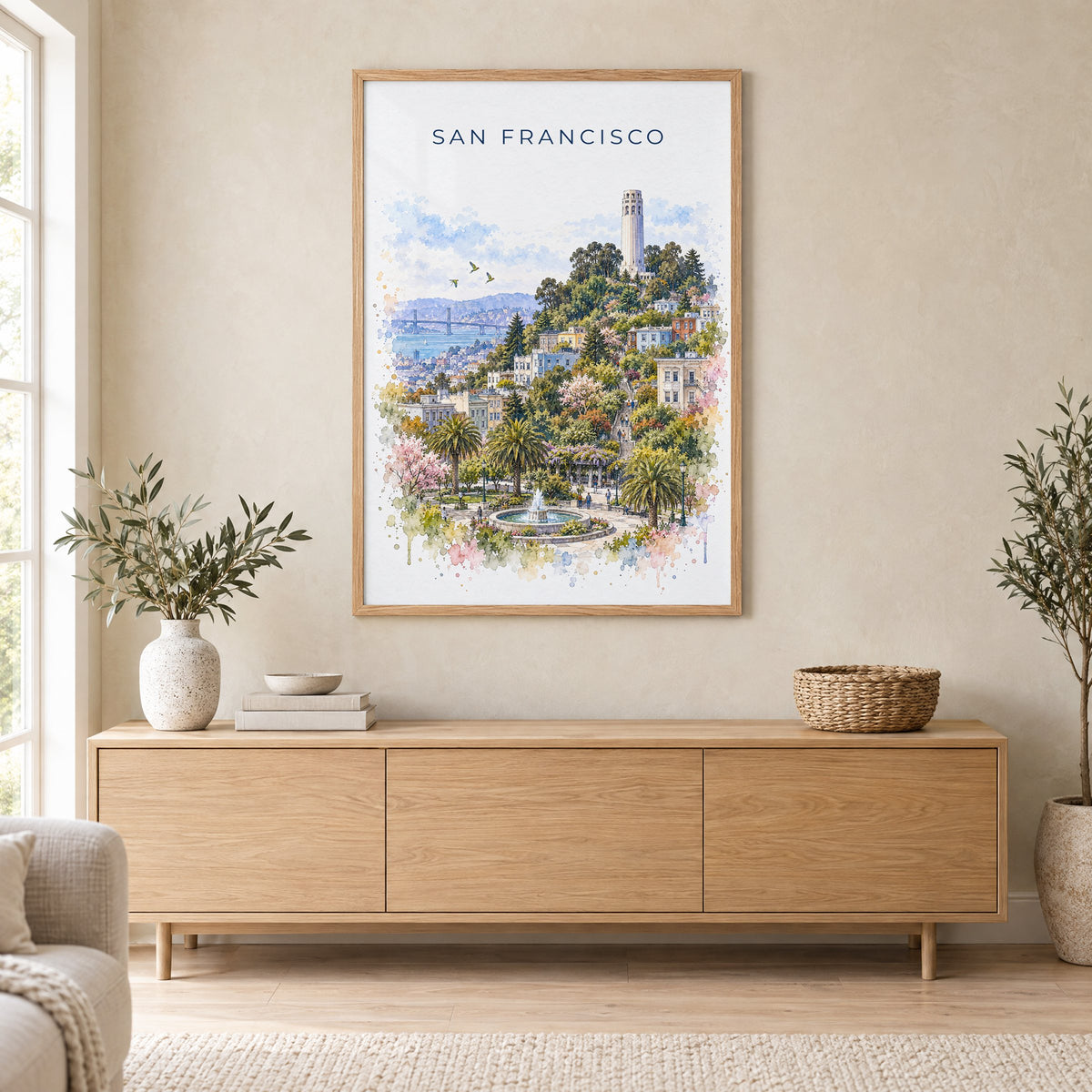 Coit Tower watercolor print in an oak frame above a light wood sideboard in a Scandinavian living room