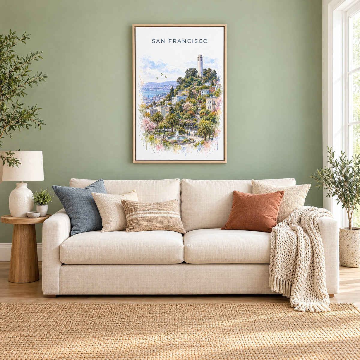 Coit Tower watercolor print as a natural floater canvas above a cream linen sofa on a sage green wall
