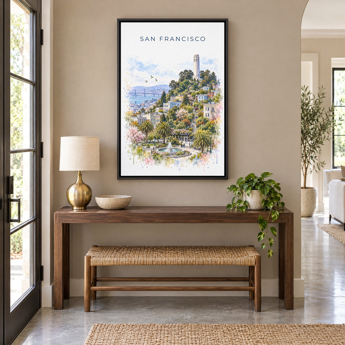 Coit Tower watercolor print as a black floater canvas above a walnut console and woven bench in an entryway