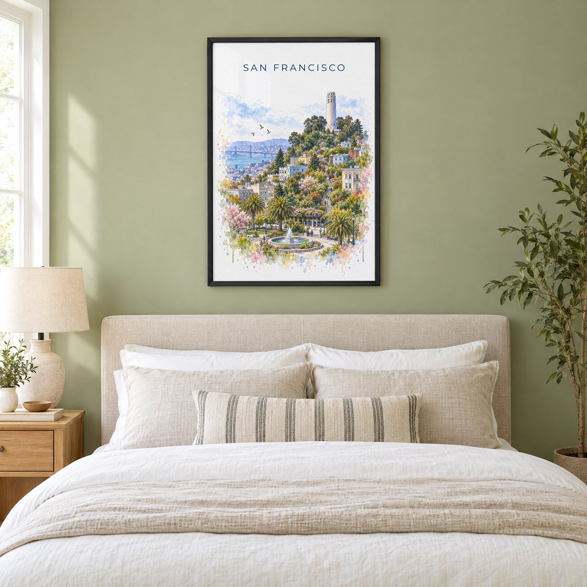 Coit Tower watercolor print in a black frame above an upholstered headboard in a sage green bedroom