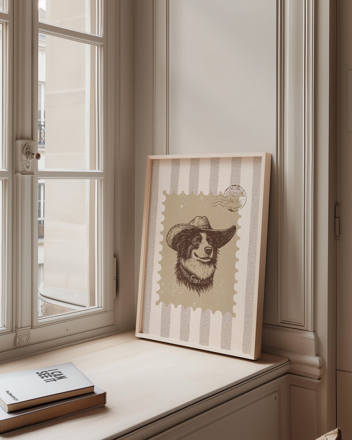 Collie cowboy hat stamp print in a pale wood frame on a sunlit window ledge