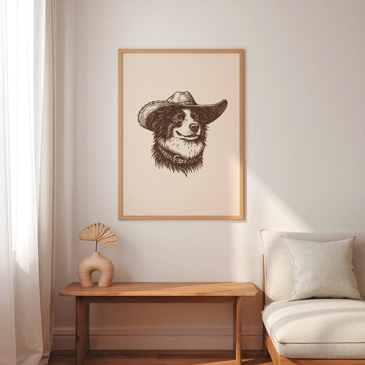 Collie in a cowboy hat print in an oak frame above a console with an arch vase