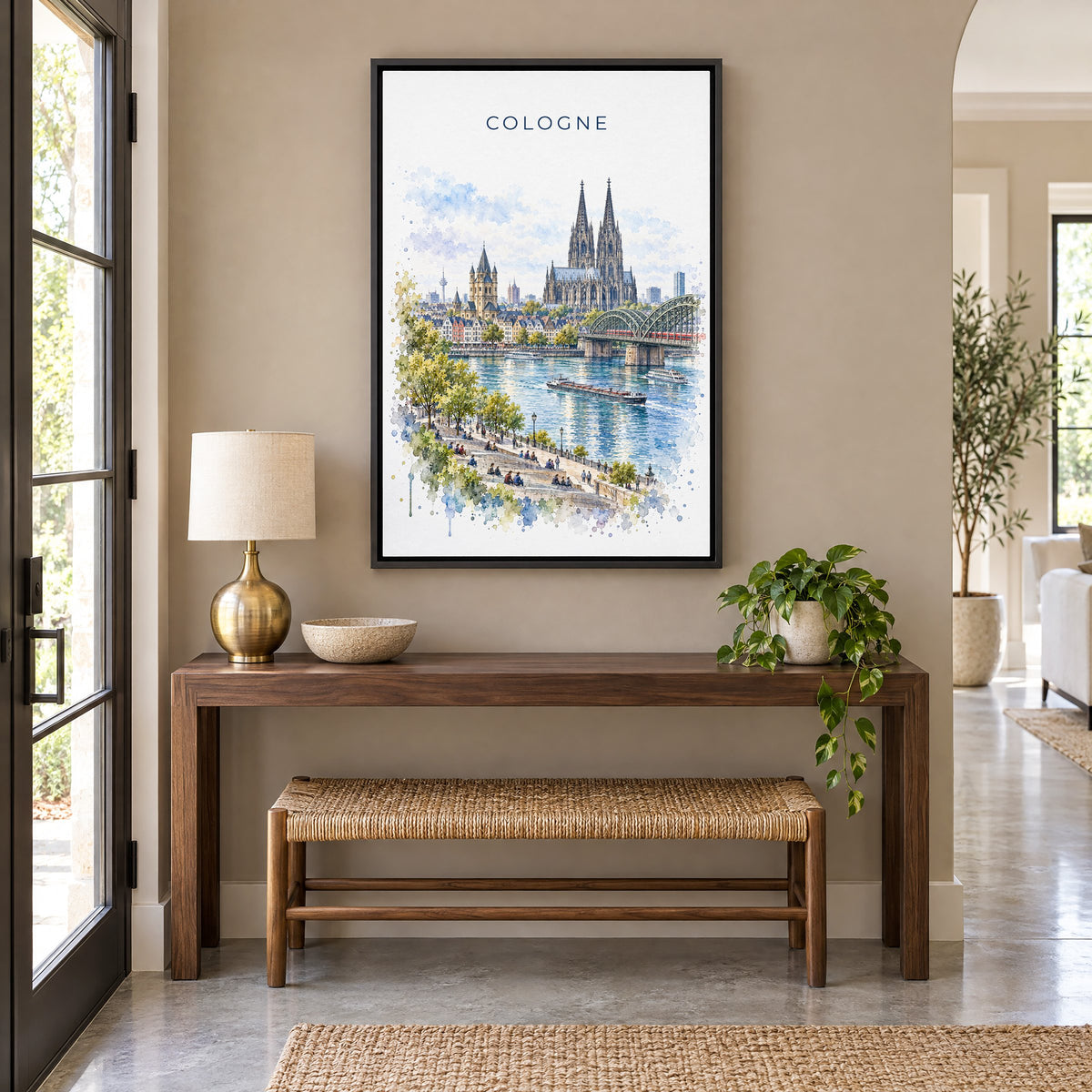 Cologne watercolor print as a black floater canvas above a walnut console and woven bench in an entryway