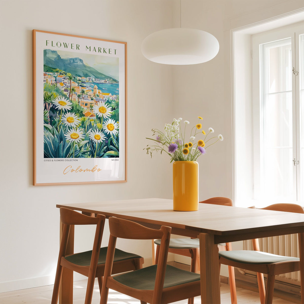 Colombo flower market print in an oak frame above a dining table with a yellow vase and white pendant light