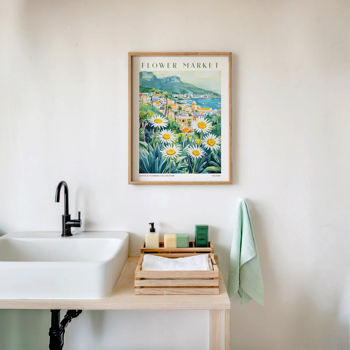 Colombo flower market print in an oak frame above a white bathroom sink with folded towels