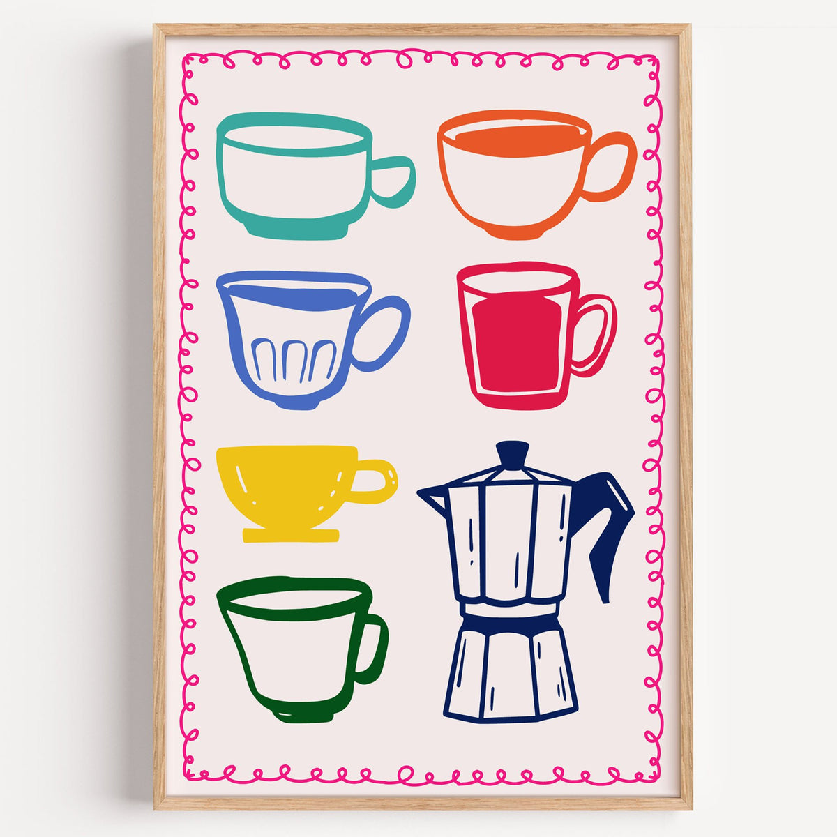 Colorful coffee cups and moka pot print in a light oak frame on a plain white wall