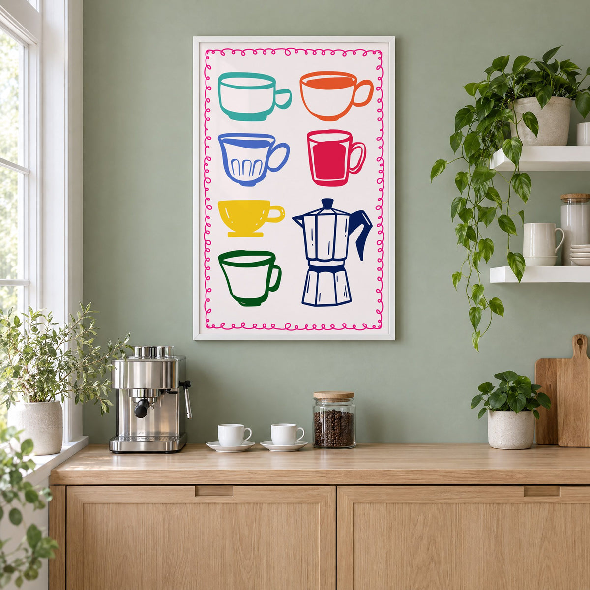 Colorful coffee cups and moka pot print in a white frame on a sage green coffee nook wall above an espresso machine