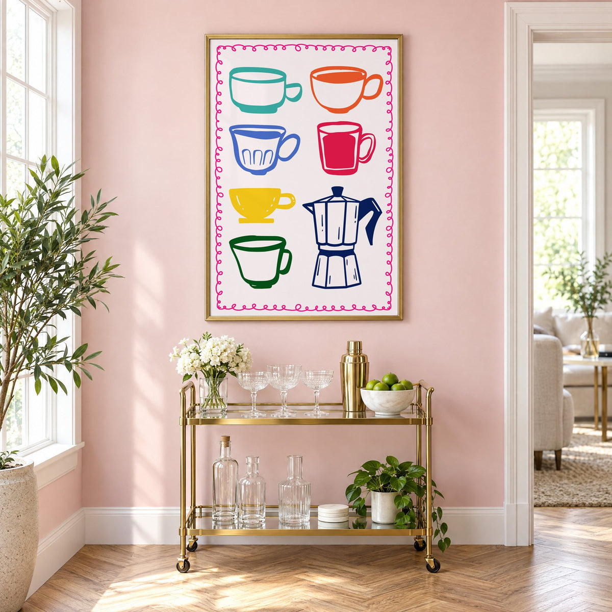 Colorful coffee cups and moka pot print in a brass frame above a gold bar cart on a blush pink wall