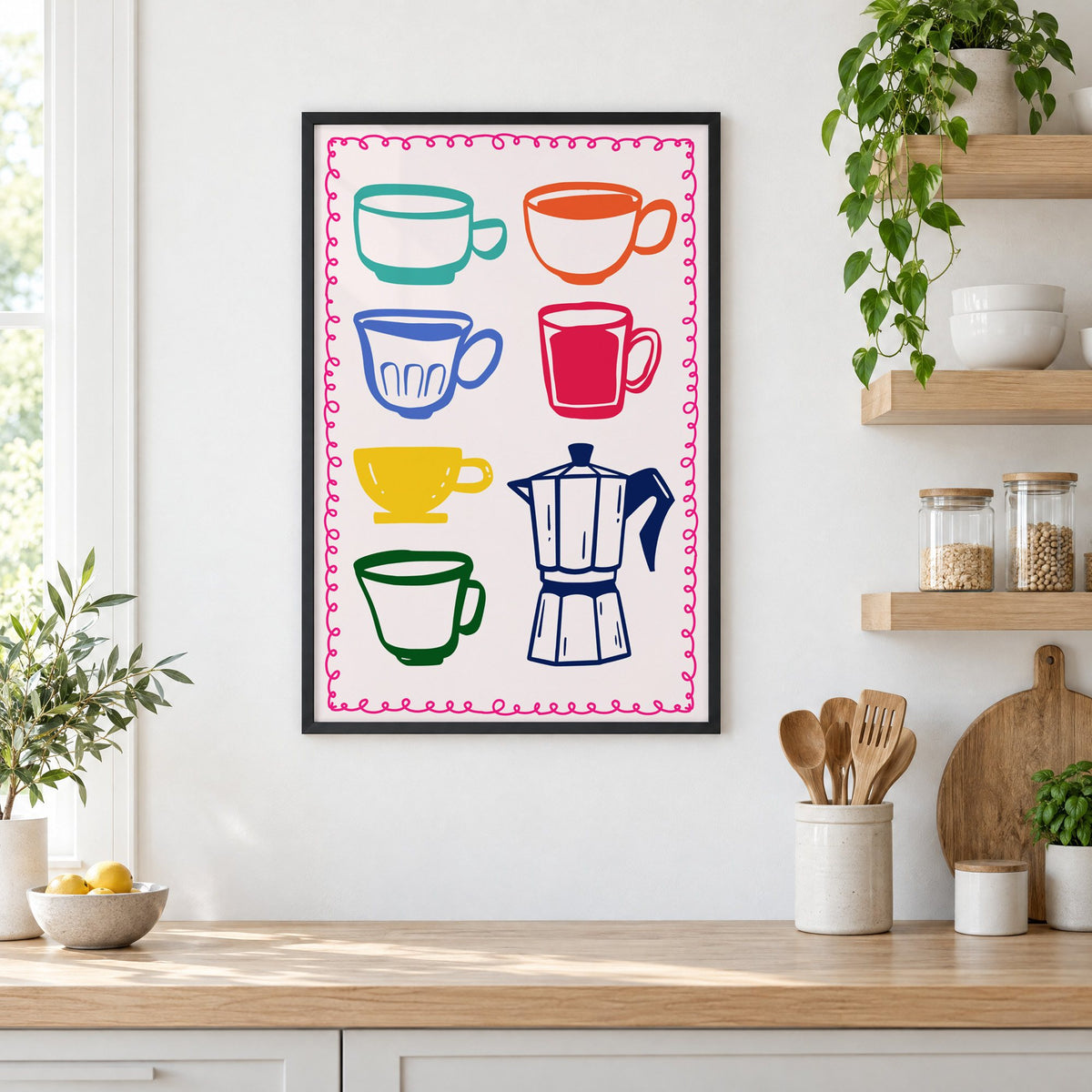 Colorful coffee cups and moka pot print in a black frame in a white kitchen beside open wood shelves and glass jars