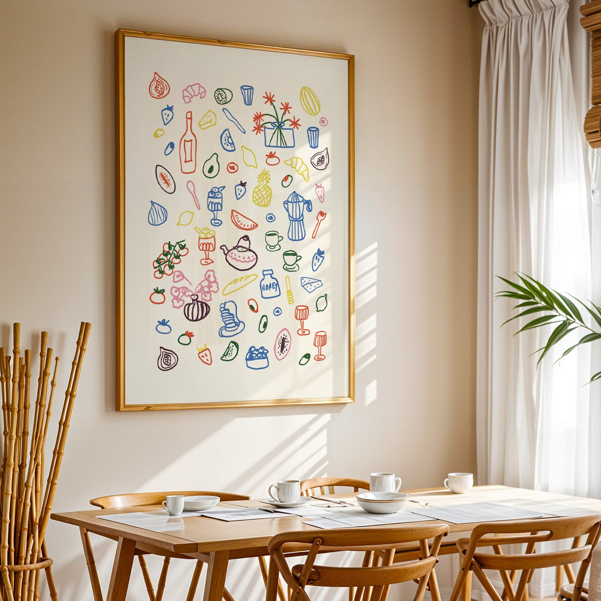 Colorful food doodle print in a gold frame above a sunlit breakfast table