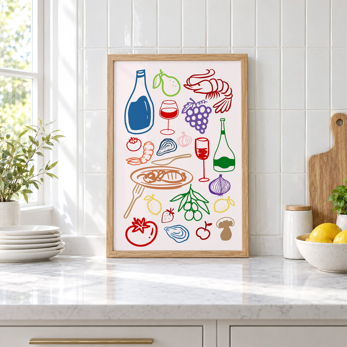 Colorful line art wine seafood feast print in an oak frame leaning on a marble counter by white tiles and lemons