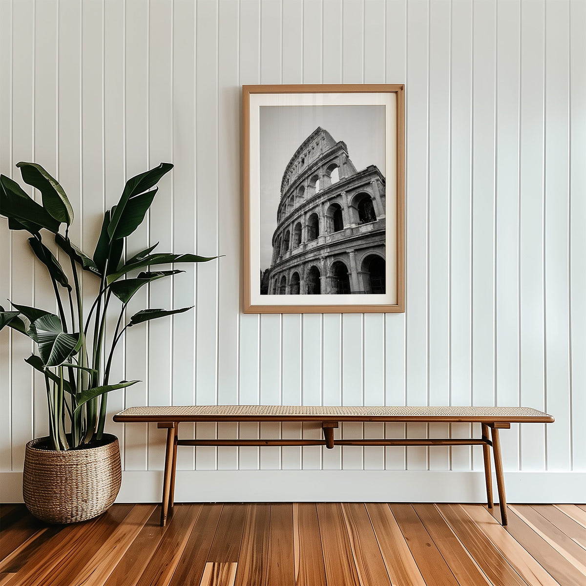 Colosseum Rome arches from below print in a wood frame with a white mat above a cane bench