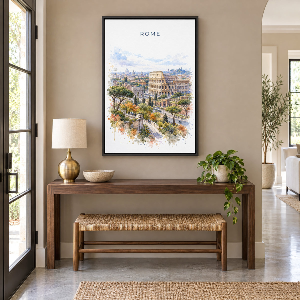 Colosseum watercolor print as a black floater canvas above a walnut console and woven bench in an entryway