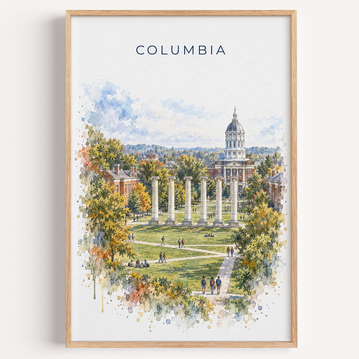 Columbia, Missouri watercolor print in a light oak frame on a plain white wall