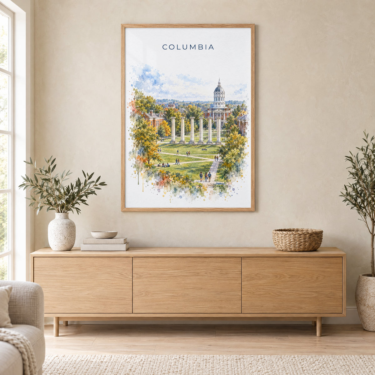 Columbia, Missouri watercolor print in an oak frame above a light wood sideboard in a Scandinavian living room