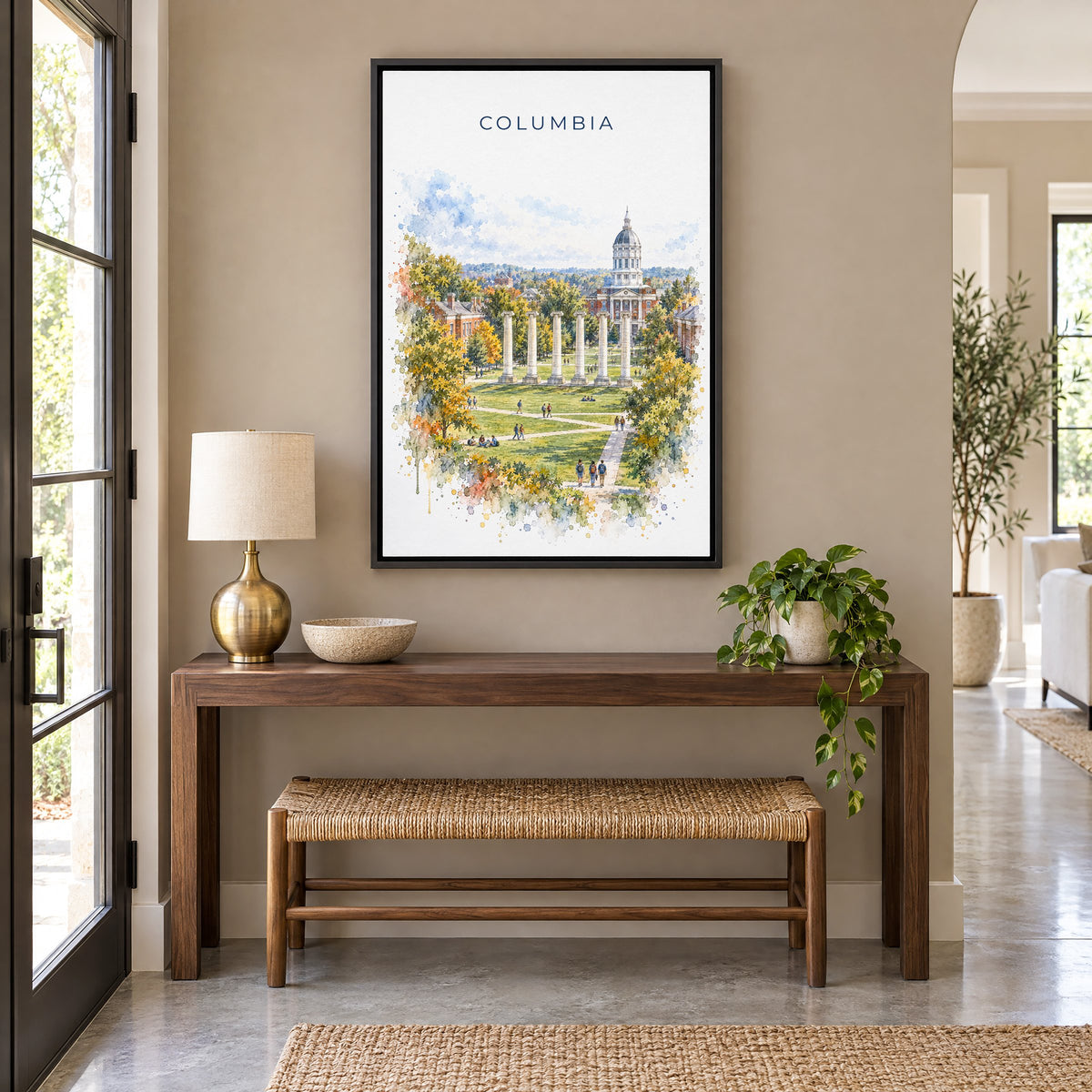 Columbia, Missouri watercolor print as a black floater canvas above a walnut console and woven bench in an entryway