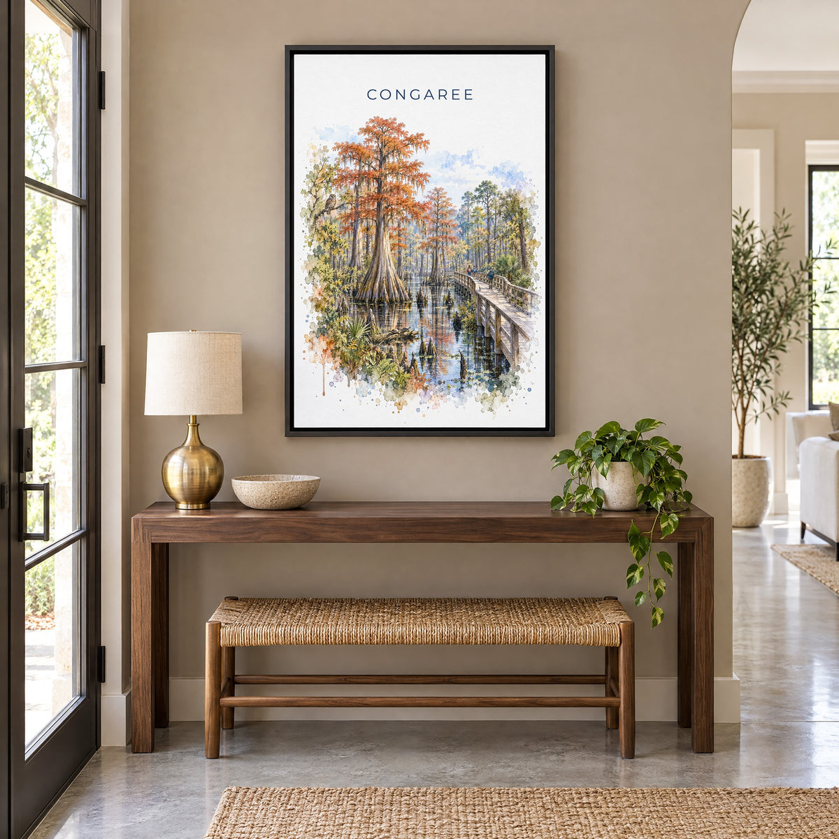 Congaree National Park watercolor print as a black floater canvas above a walnut console and woven bench in an entryway