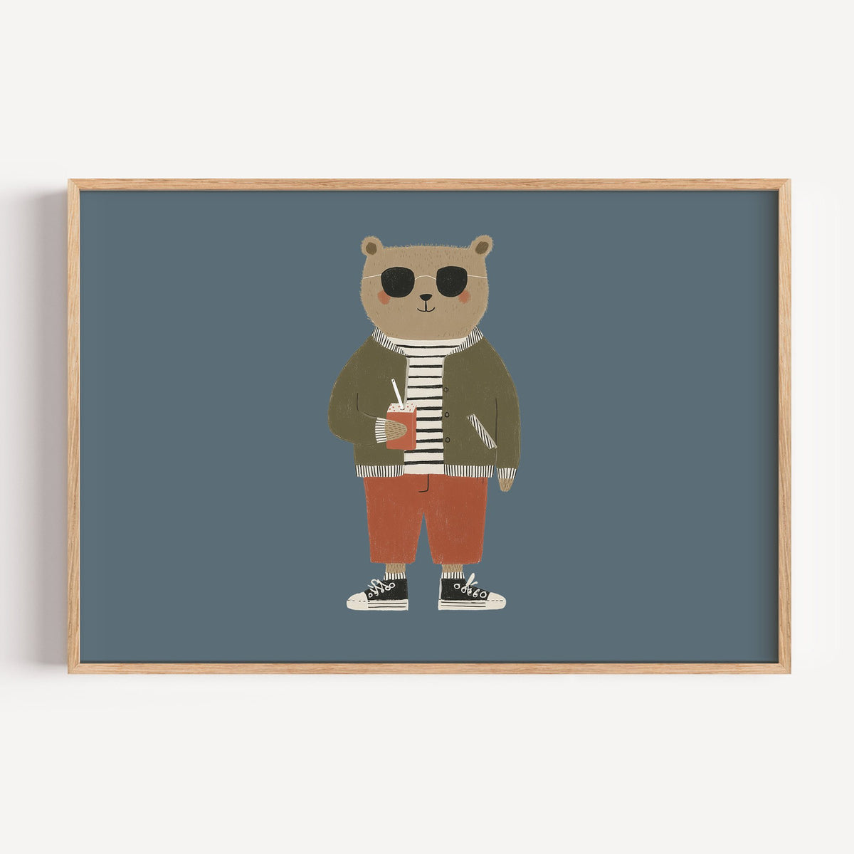 Landscape cool bear sunglasses juice box nursery print in a light oak frame on a plain white wall
