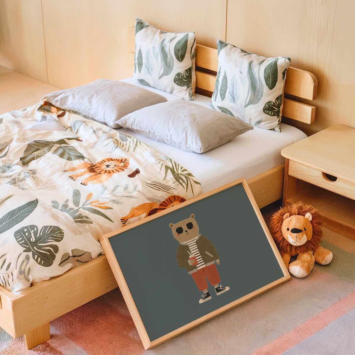 Landscape cool bear sunglasses juice box nursery print in an oak frame leaning on a kids bed by a lion plush