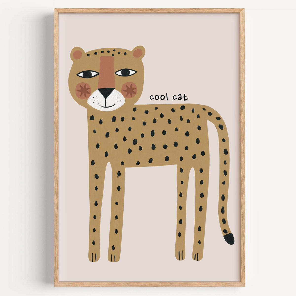 Cool cat cheetah nursery print in a light oak frame on a plain white wall