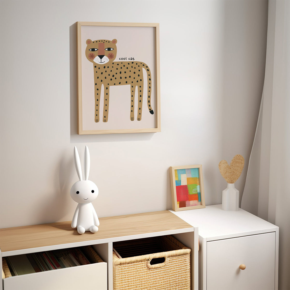 Cool cat cheetah nursery print in an oak frame above a kids cubby shelf with a woven basket and bunny lamp