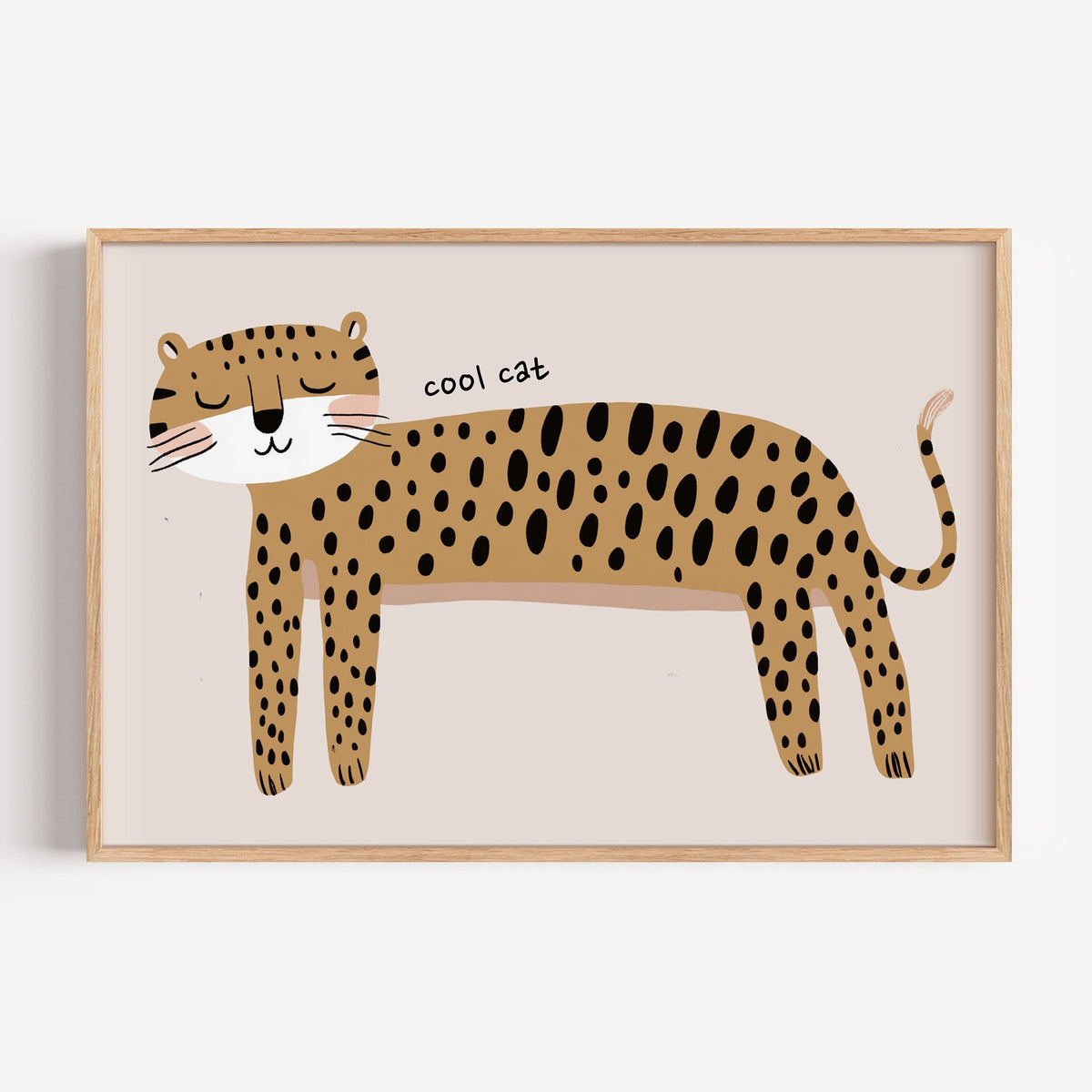 Landscape cool cat cheetah nursery print in a light oak frame on a plain white wall