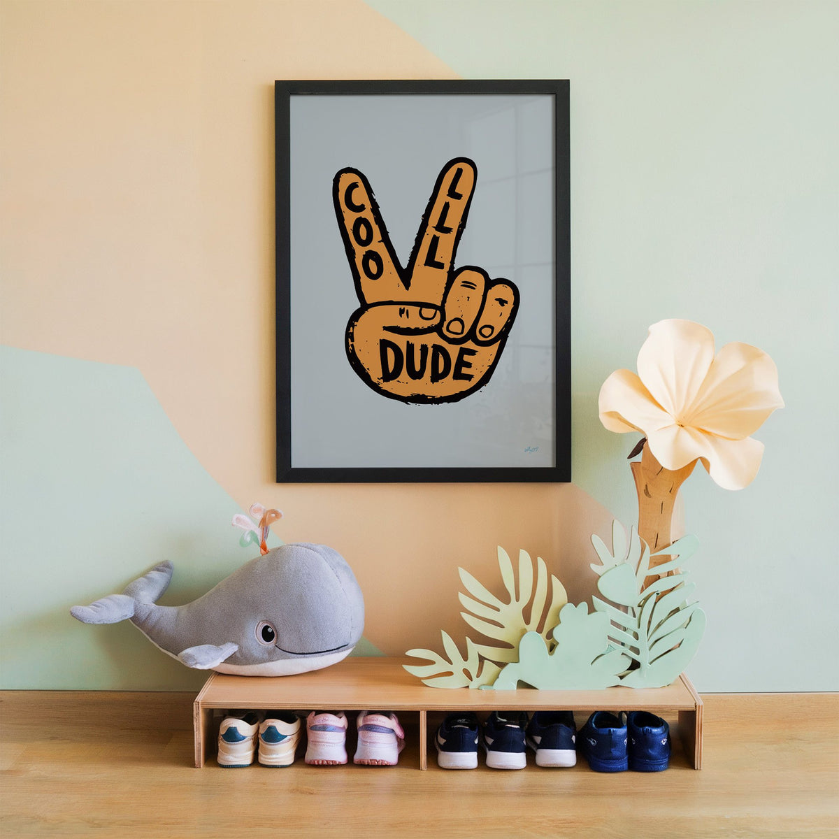 Cool dude peace sign hand nursery print in a black frame on a mint and peach wall above a whale plush
