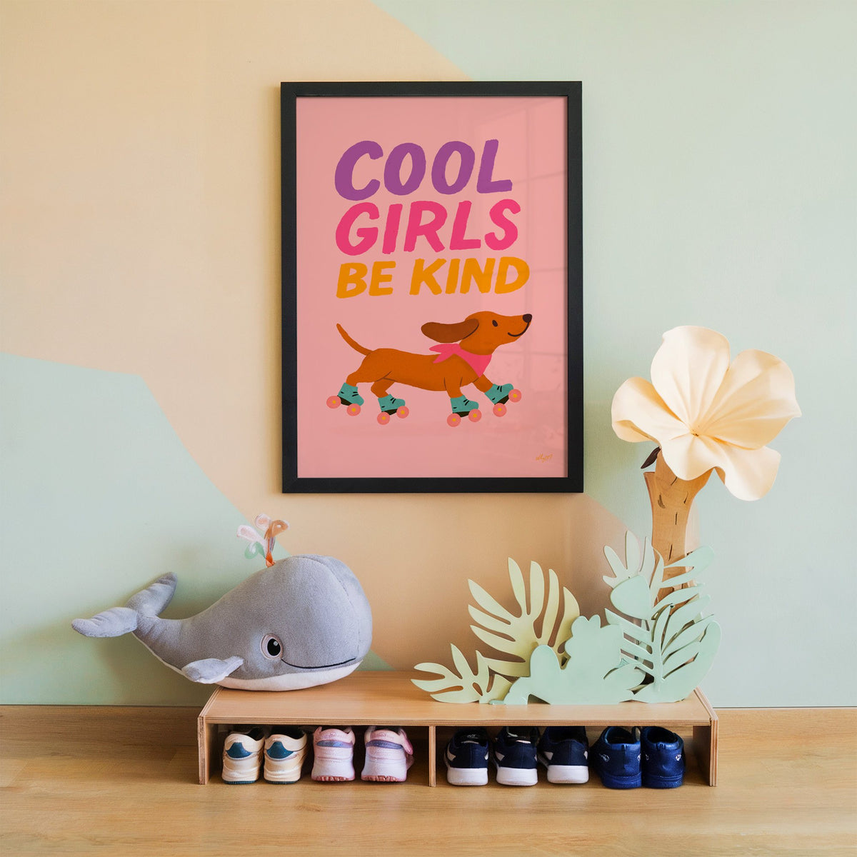 Cool girls be kind dachshund nursery print in a black frame on a mint and peach wall above a whale plush