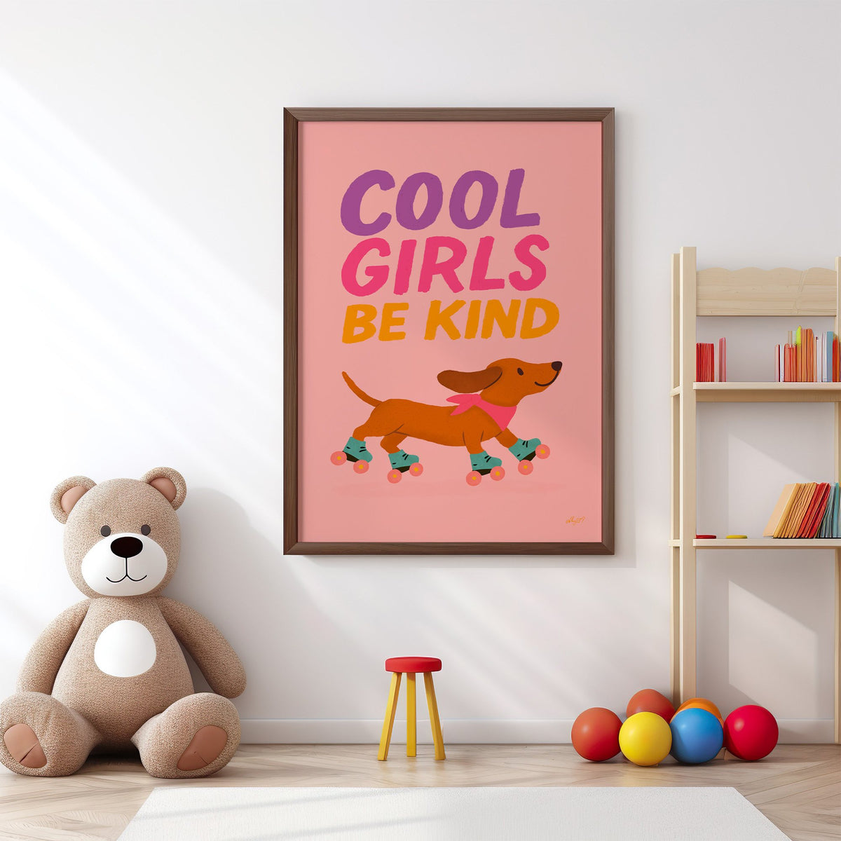 Cool girls be kind dachshund nursery print in a walnut frame above a big teddy bear by a bookshelf