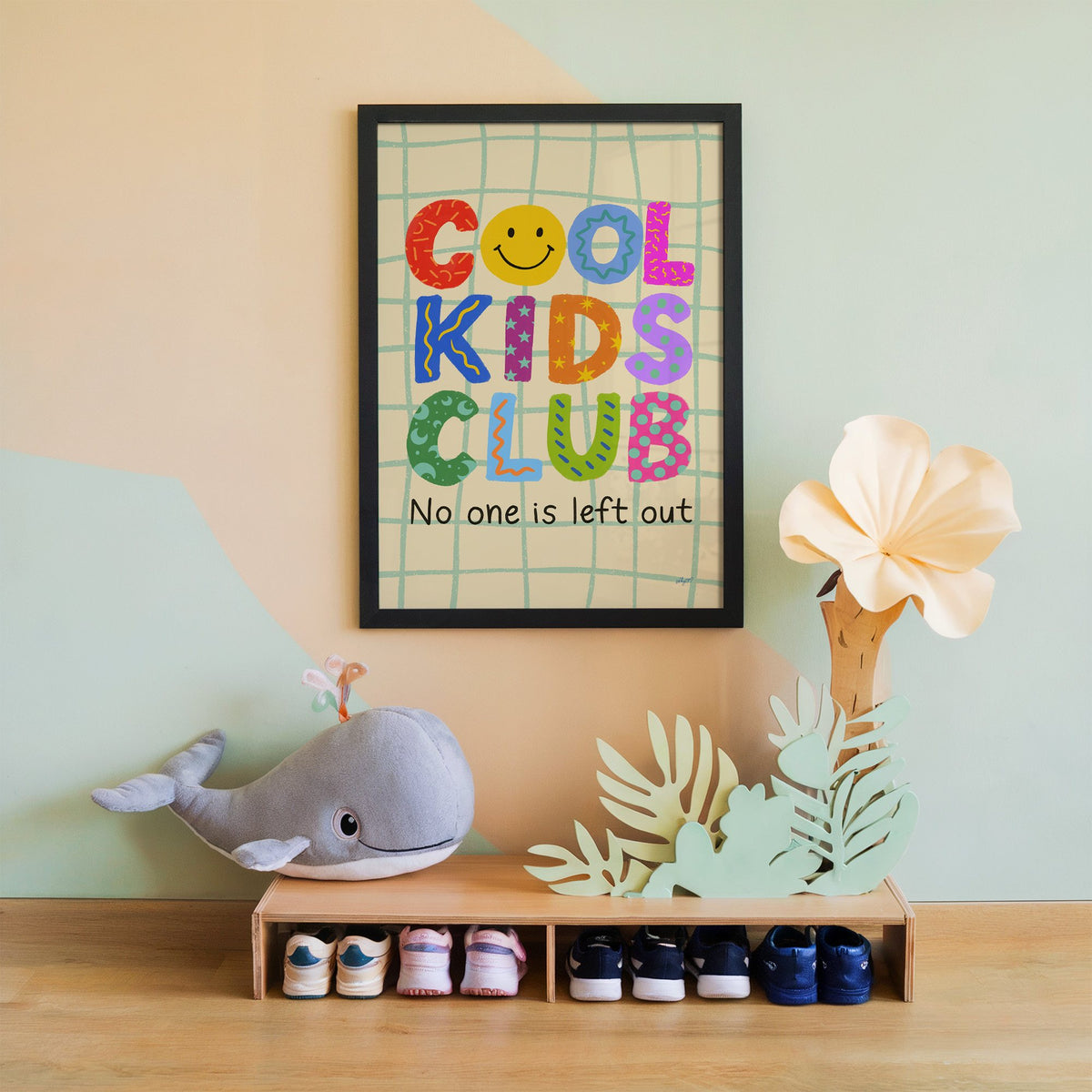 Cool kids club colourful letters nursery print in a black frame on a mint and peach wall above a whale plush