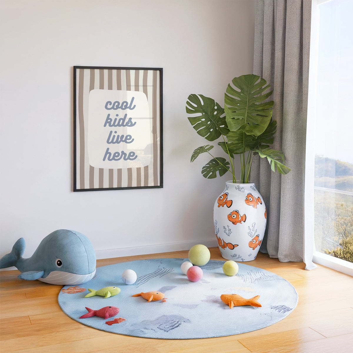 Cool kids live here nursery print in a black frame in a playroom with an ocean rug and whale plush