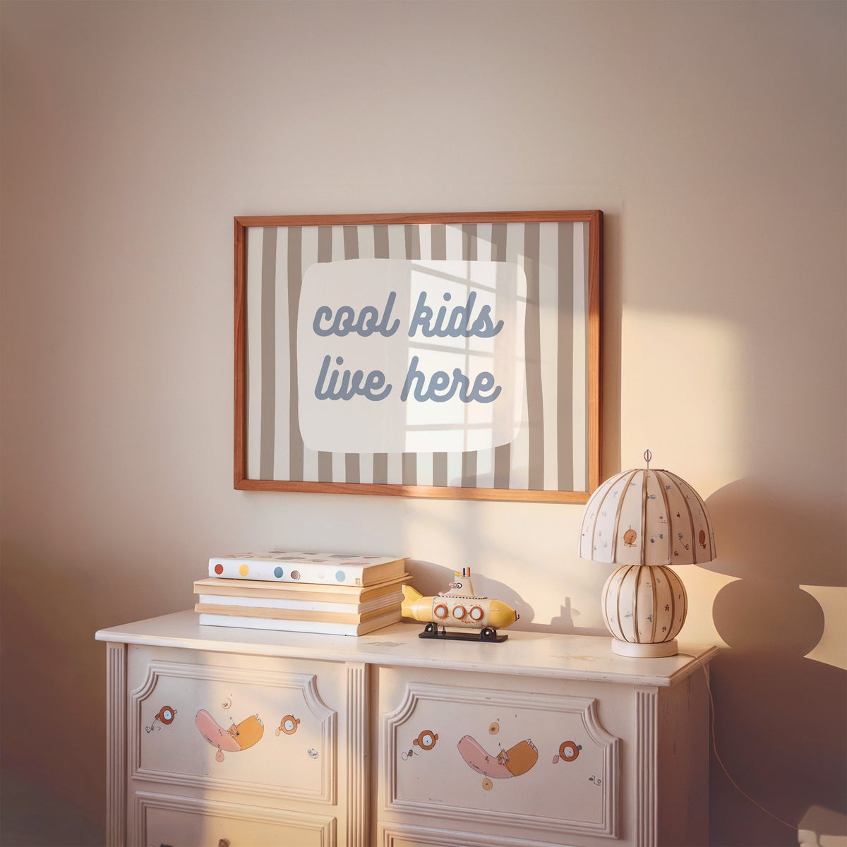 Landscape cool kids live here nursery print in a cherry wood frame above a painted dresser and lamp