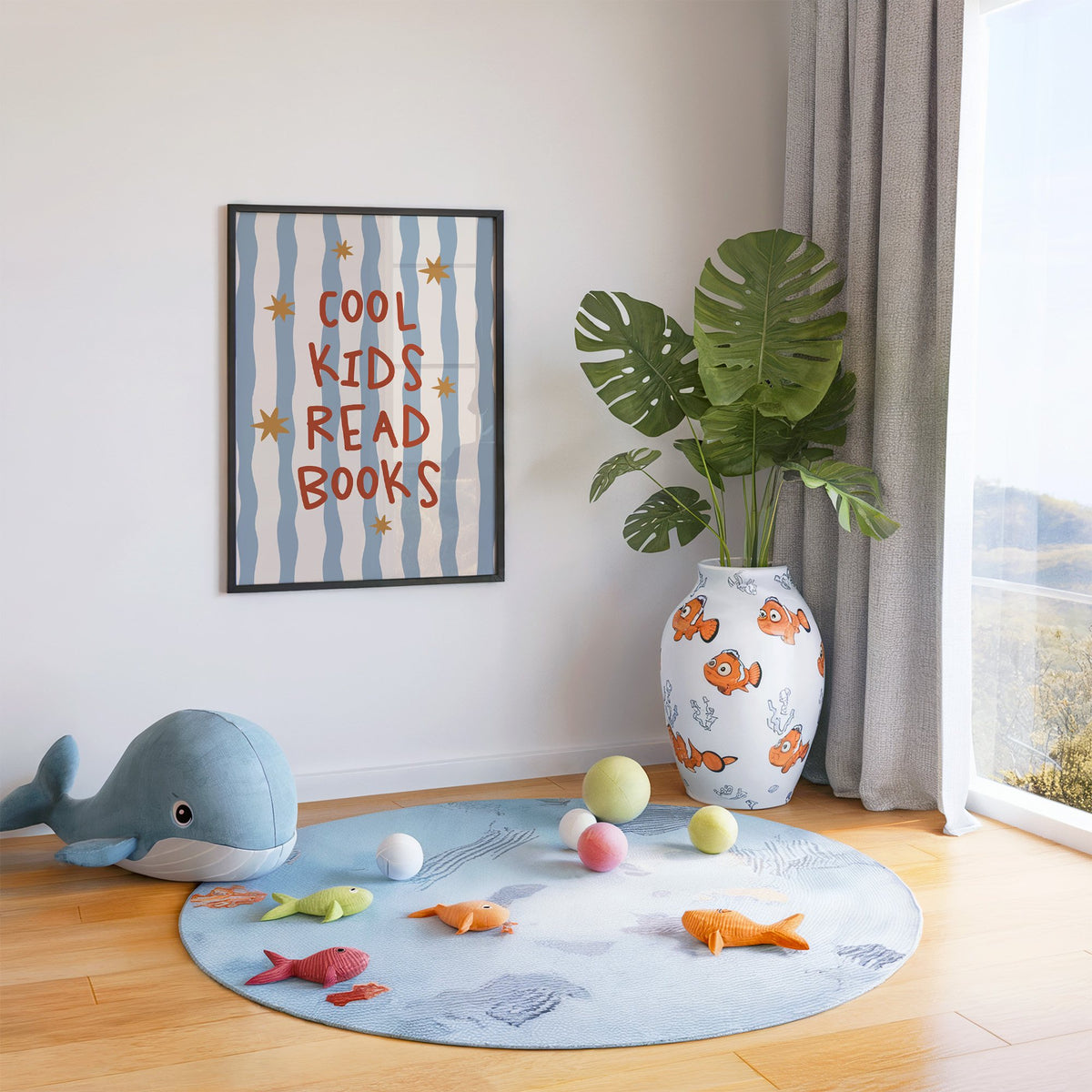 Cool kids read books gold stars nursery print in a black frame in a playroom with an ocean rug and whale plush