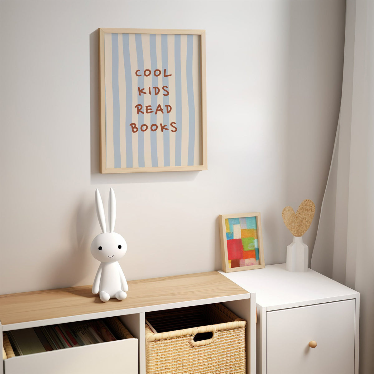 Cool kids read books blue stripe nursery print in an oak frame above a kids cubby shelf with a woven basket and bunny lamp