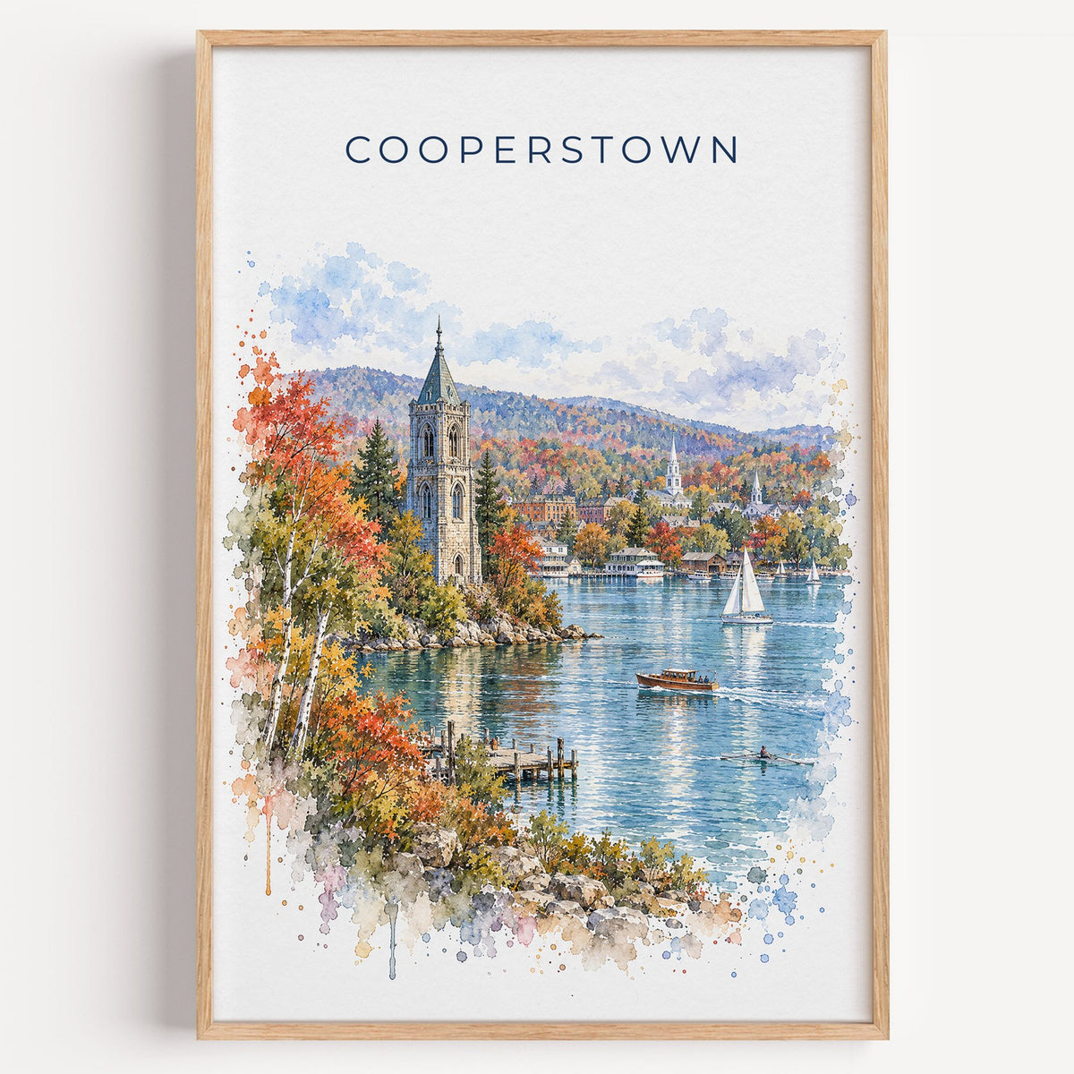 Cooperstown watercolor print in a light oak frame on a plain white wall