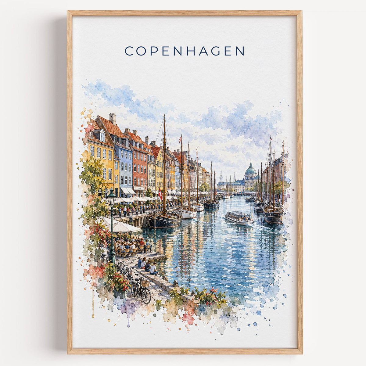 Copenhagen watercolor print in a light oak frame on a plain white wall