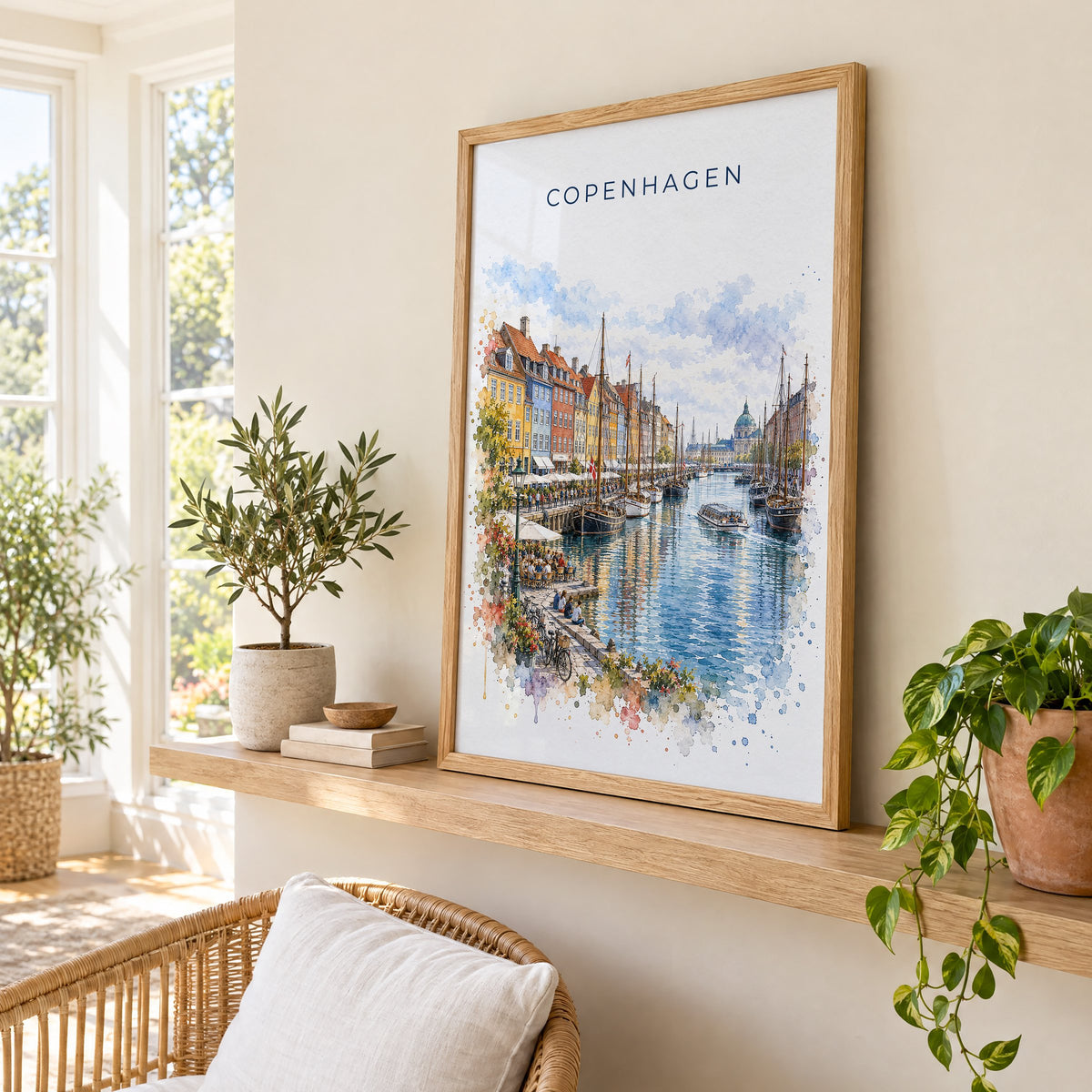 Copenhagen watercolor print in an oak frame on a picture ledge in a sunlit sunroom